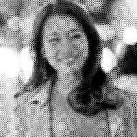 a black and white photo of a woman smiling