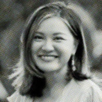 a black and white photo of a woman smiling