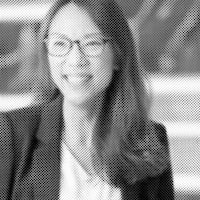 a black and white photo of a woman wearing glasses