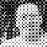 a black and white photo of a man smiling